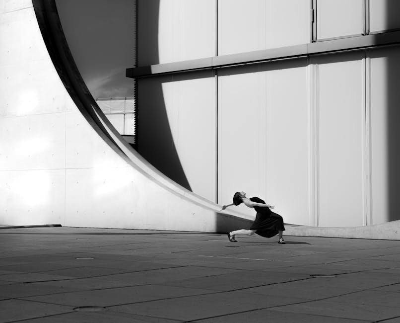 Elegant dance pose captures dynamic movement against Berlin's modern architectural backdrop.